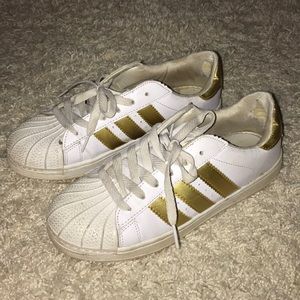 Gold adidas super stars